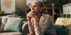 older woman sitting considering depression affecting aging