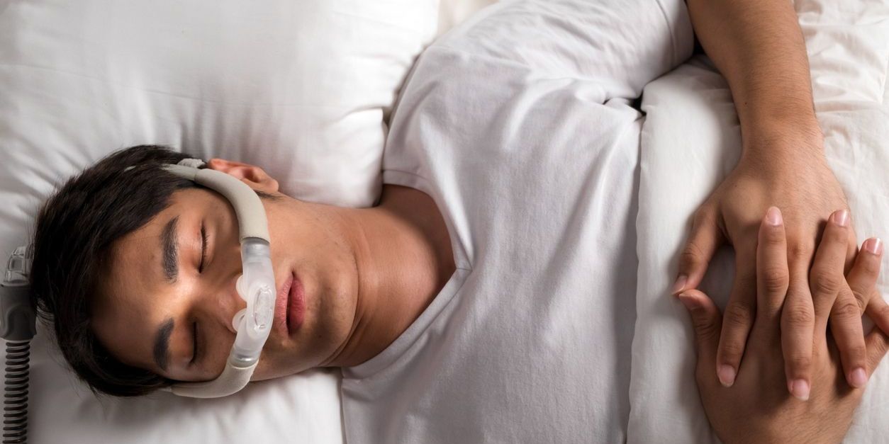 man sleeping with cpap for sleep apnea