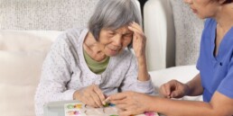older adult with cognitive impairment being helped