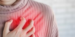 woman grasping at heart area